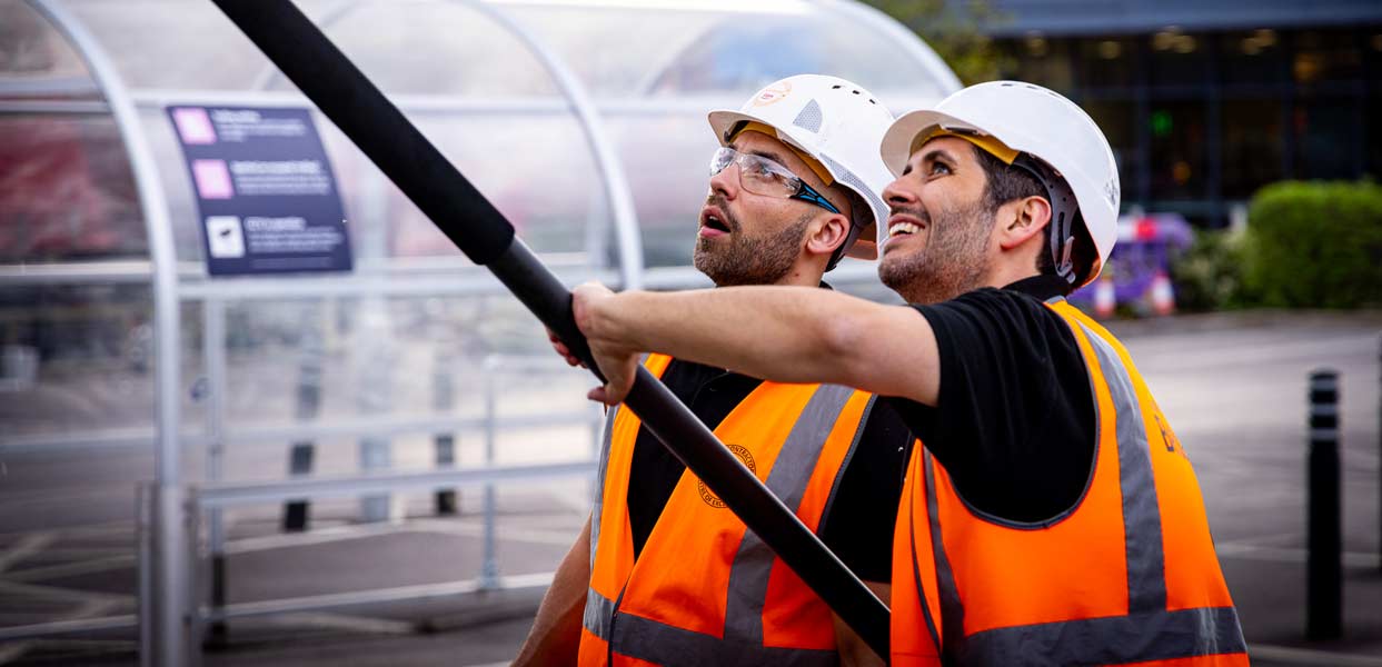 team-exterior-clean-safety Team Safely Cleaning Building Exterior